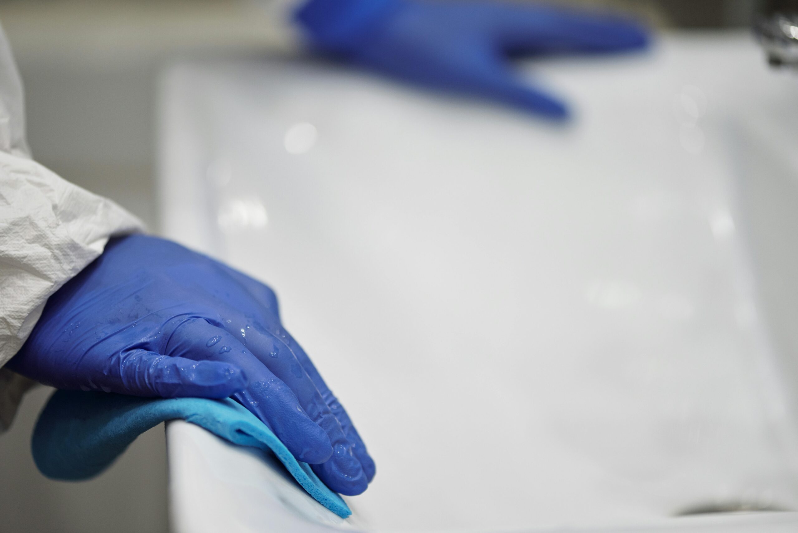 person washing reusable pads in sink