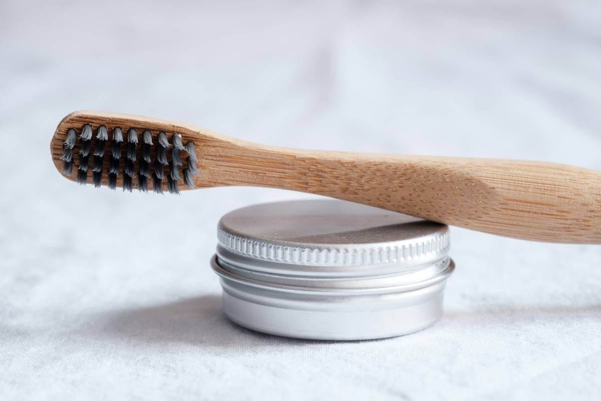 A close-up image of an organic cotton pad with green leaves around it symbolizing its natural ingredients