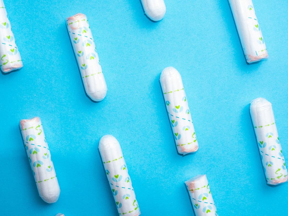 a group of white pills sitting on top of a blue surface