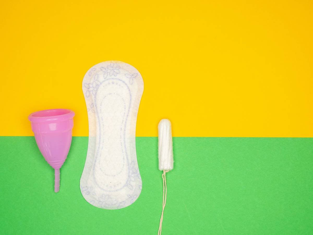 a hairdryer and a pair of shoes on a green and yellow background