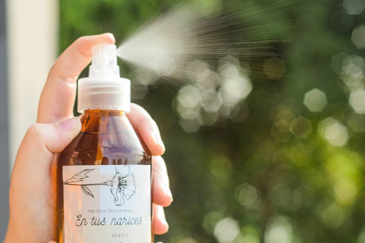 a person is holding a bottle of soap