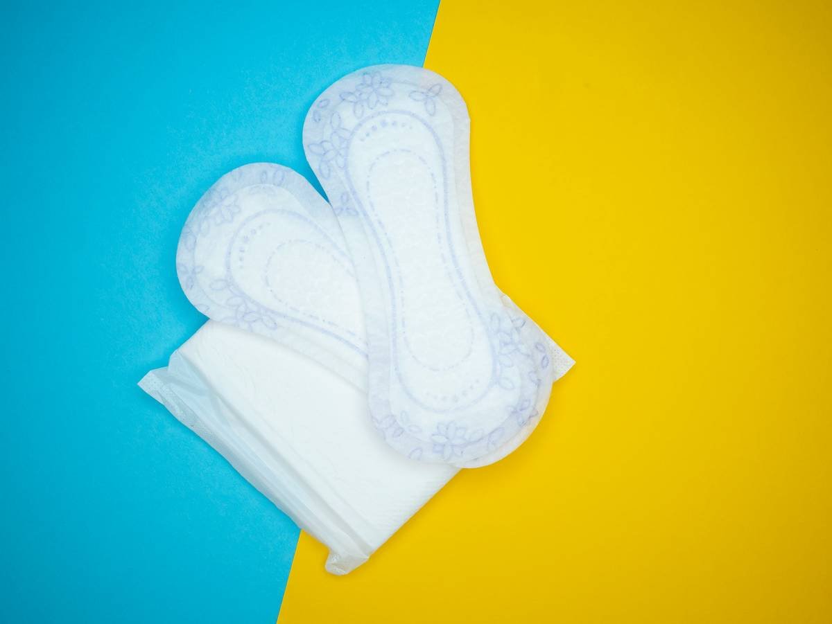 a pair of white gloves sitting on top of a yellow and blue background