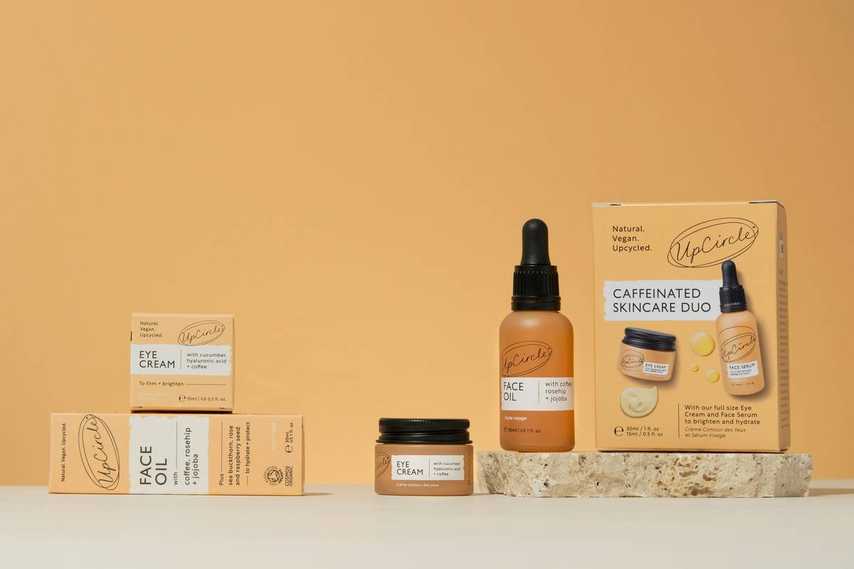 A premium skincare duo featuring UpCircle’s natural, vegan, and upcycled beauty products. This image showcases the Caffeinated Skincare Duo, including a Face Oil with coffee, rosehip, and jojoba, and an Eye Cream enriched with cucumber, hyaluronic acid, and coffee extract. Captured against a warm, earthy backdrop, this minimalist and sustainable skincare flat lay embodies eco-conscious beauty. Ideal for promoting organic skincare, cruelty-free beauty, and sustainable self-care routines.