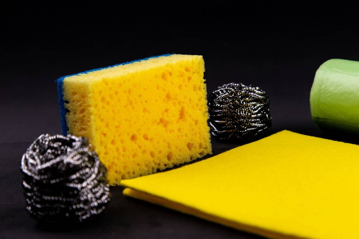 Dishwashing concept. On a black background, different washcloths and scrubbers for washing dishes