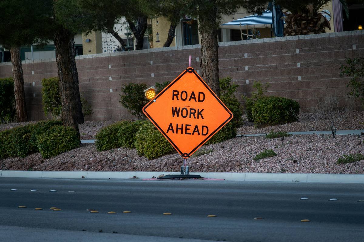 Orange road work ahead sign on a street
